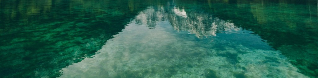 Clear calm lake with mountain reflection