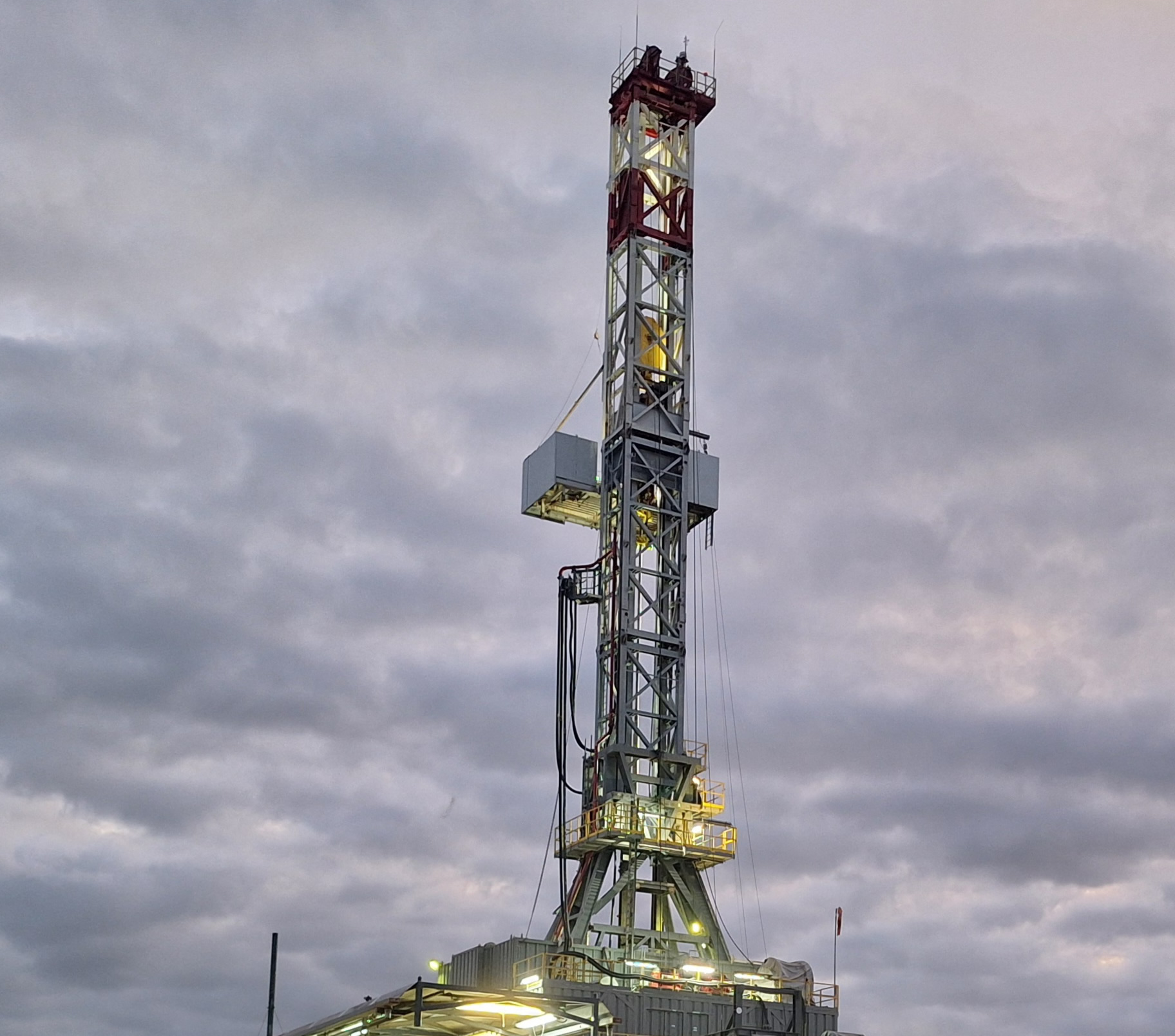 Drilling rig on site against blue sky
