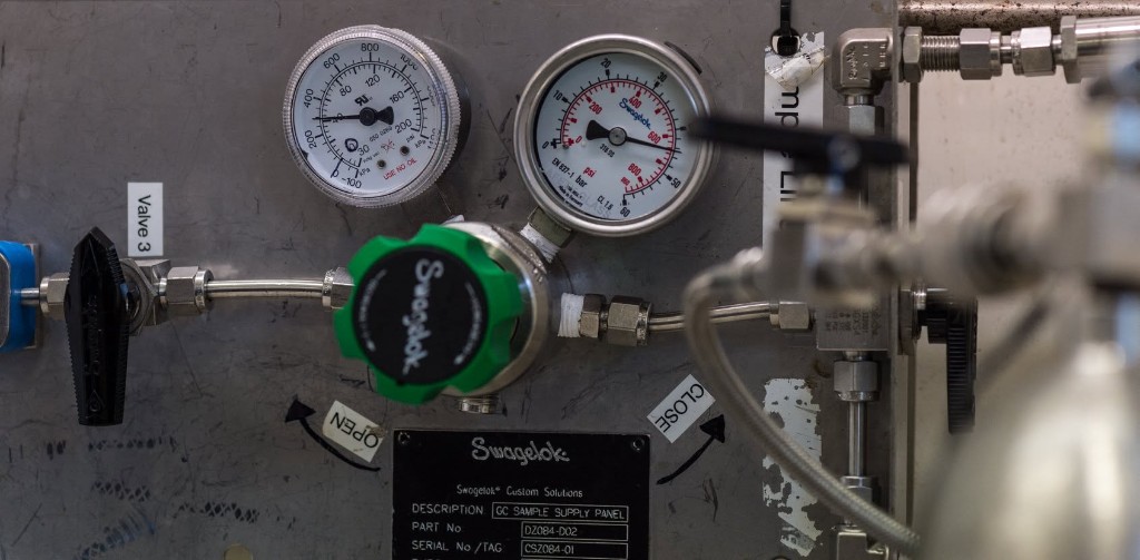 Industrial gas sample supply panel with pressure gauges and flow control valves