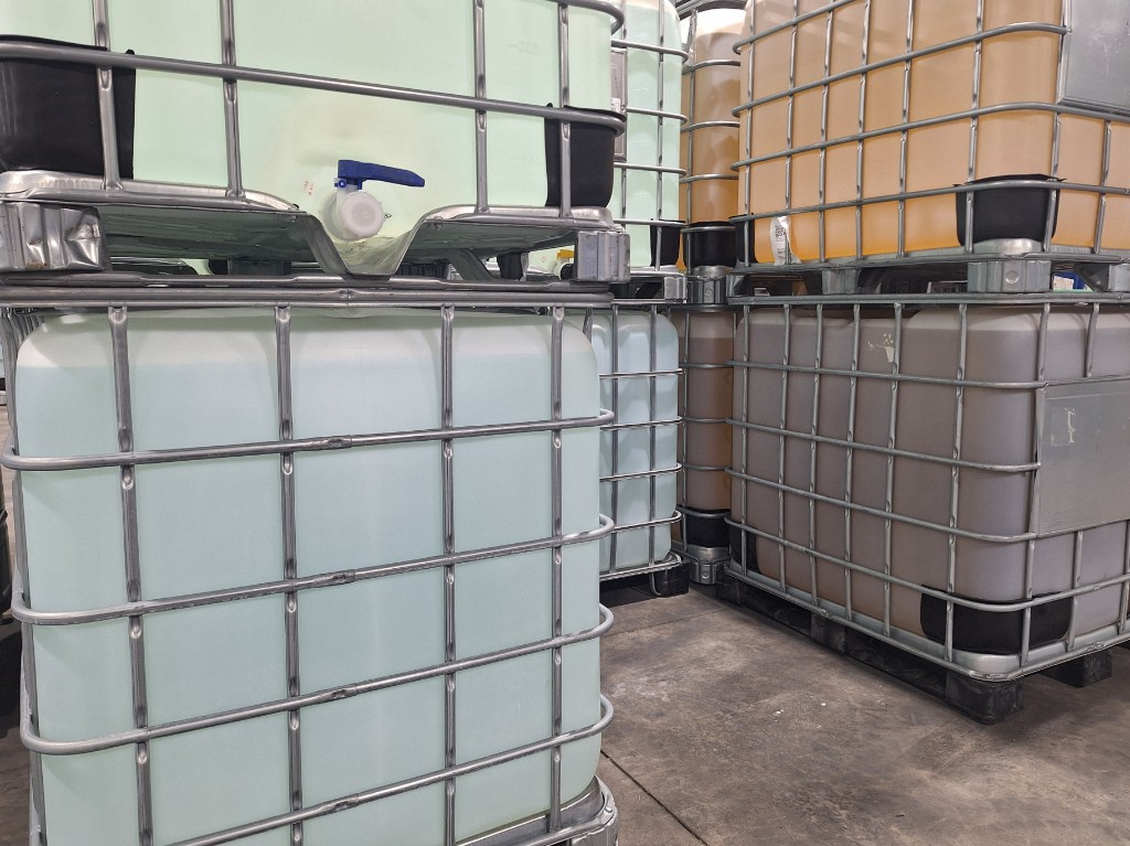 Stacked IBC totes containing ENACo surfactant formulations in warehouse storage